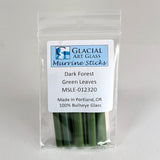 A package of Murrine Sticks, a type of green glass, with a label indicating that they are made in Portland, Oregon and are 100% Bullseye Glass.