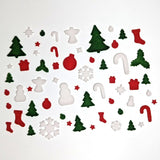 Collection of Christmas-themed fusible glass powder wafers on a white background