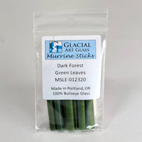 A package of Murrine Sticks, a type of green glass, with a label indicating that they are made in Portland, Oregon and are 100% Bullseye Glass.