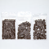 Three clear plastic bags filled with chocolate pieces are arranged in a row.