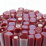 a close-up view of numerous red and purple glass rods or sticks arranged in a visually appealing manner.