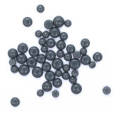 a collection of numerous small, round, black objects scattered across a white background.