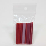 A clear plastic bag containing a group of red and pink tubes or sticks.