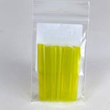 A clear plastic bag containing a group of yellow plastic tubes or sticks.
