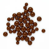 a collection of brown chocolate spheres arranged in various positions on a white background.
