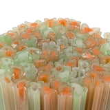 a close-up view of a collection of colorful, translucent objects, possibly made of glass or a similar material. The objects appear to be arranged in a circular pattern, with some overlapping each other. The colors of the objects are predominantly green and orange, creating a vibrant and visually striking display.