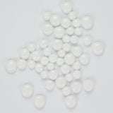 a collection of white, round beads or spheres scattered across a plain white background.