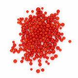 a large pile of small, round, red objects scattered on a white background.
