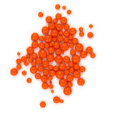 numerous small, round orange balls scattered across a white background.