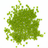 a large pile of green, spherical objects scattered on a white background.
