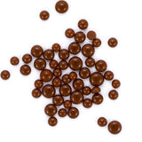 a collection of brown, round chocolate candies scattered on a white background.