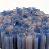 a close-up view of numerous blue and white candles arranged in a visually appealing manner.