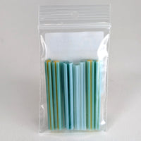 A clear plastic bag containing a collection of green and yellow straws.