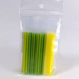 A clear plastic bag containing a collection of green and yellow straws.