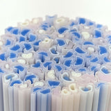 The image is a close-up of a collection of blue and white tubes or tubes with a repeating pattern of blue and white shapes.