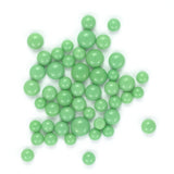 a collection of green beads or spheres, scattered across a white background.