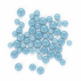 a collection of small, round blue beads or stones arranged in a scattered pattern.