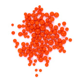 numerous small, round orange balls scattered across a white background.