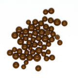 a collection of brown chocolate balls scattered on a white background.