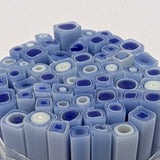 a collection of blue and white cylindrical objects, possibly made of glass or plastic, arranged in a visually appealing manner.
