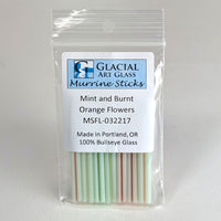 A package of Glacial Art Glass Murrine Sticks, which are mint and burnt orange flowers.