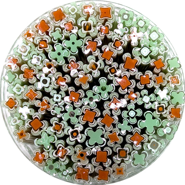 The image is a circular arrangement of various colored straws, including green and orange ones, creating a visually interesting and vibrant display.
