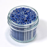 A glass jar filled with blue and white flower-shaped objects, possibly artificial flowers or decorative elements.