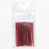 A clear plastic bag containing a set of red plastic tubes.