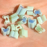 a collection of small, colorful beads or buttons arranged on a surface.