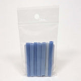 A clear plastic bag containing a group of blue and white cylindrical objects, which appear to be small, cylindrical objects.