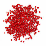 a large pile of red beads or spheres scattered on a white background.