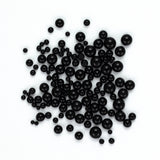 a large number of black spherical objects scattered across a white background.