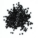 a large number of black beads or spheres scattered across a white background.