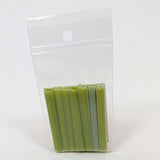 A clear plastic bag containing a row of green plastic tubes or sticks.