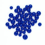 a collection of blue plastic balls scattered across a white background.