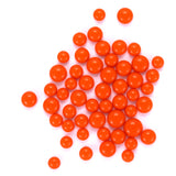 numerous small, round orange balls scattered across a white background.