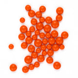 numerous small, round orange balls scattered across a white background.