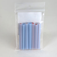 A clear plastic bag containing a group of blue and red straws.