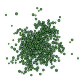 a large number of small, green beads or spheres scattered across a white background.