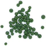 a collection of green beads or spheres scattered across a white background.