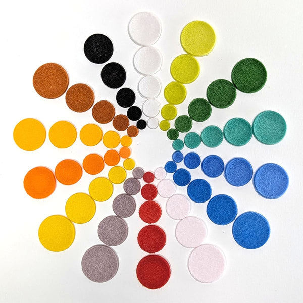 Set of colorful Powder Wafer Circles made from fusible COE 96 glass arranged in a circular pattern on a white background