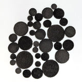 The contents of one bag of fusible glass powder wafers - black variation