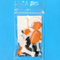 Packaged Halloween-themed decorations including pumpkins, ghosts, and bats on a blue background.