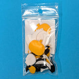 The back of the bagged product: an assortment of glass Halloween shapes in on a blue background