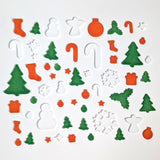 Collection of Christmas-themed fusible glass COE 90 shapes on a white background
