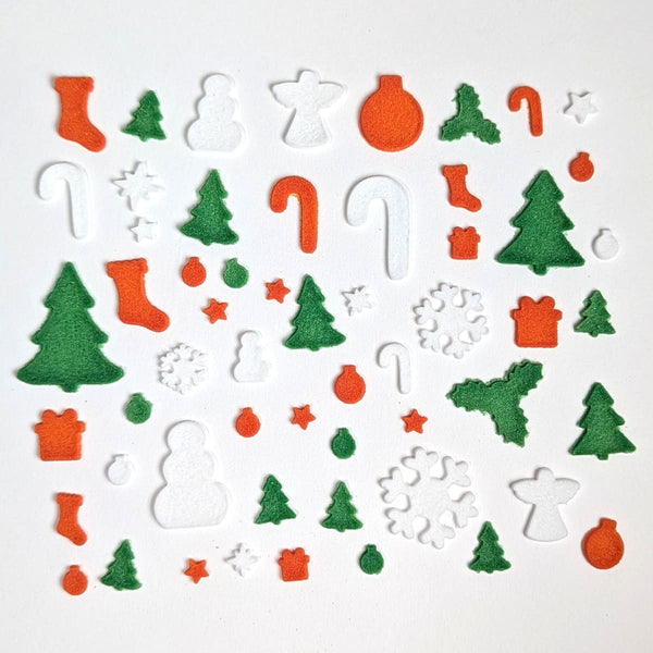 Collection of Christmas-themed fusible glass COE 90 shapes on a white background