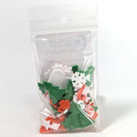 Packaged Christmas-themed fusible glass powder wafers on a white background.