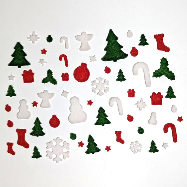 Collection of Christmas-themed fusible glass powder wafers on a white background