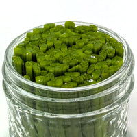 A glass jar filled with green, sliced vegetables.
