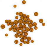numerous small, round objects that appear to be made of a shiny, golden material. They are scattered across a white background, creating a visually striking contrast.